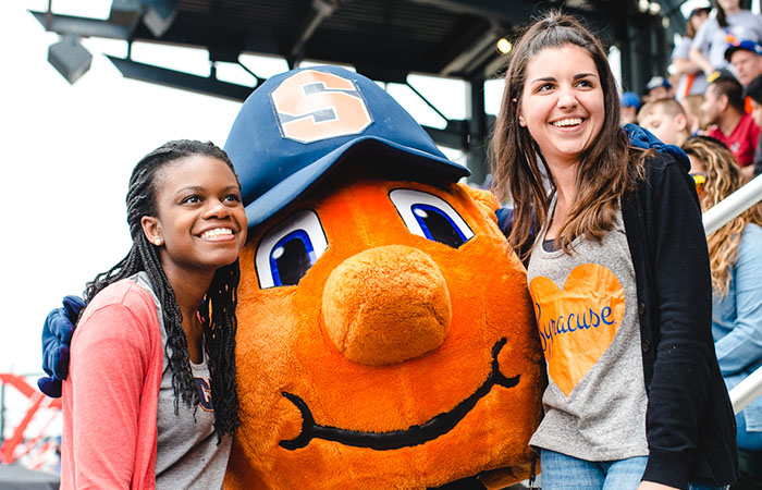 Two regional alumni with Otto at a baseball game