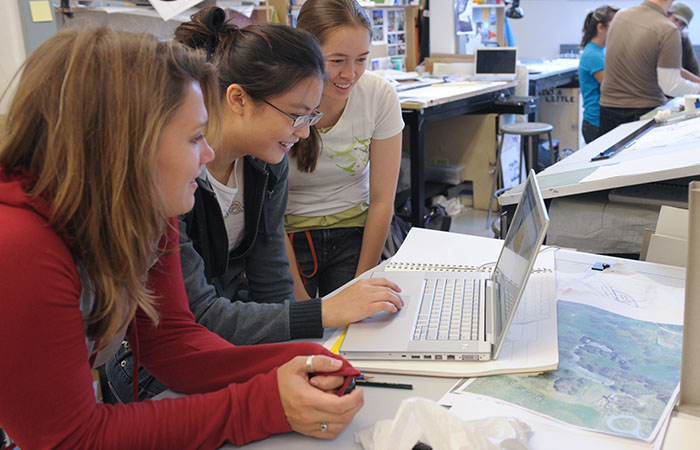 Students collaborating on a laptop