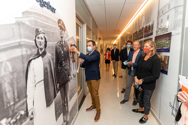 The Johnston Family looks on as Pierce H. Johnston ’19 unveils their space: The SSG Arthur Harrison, USA Community Room, in memory of his service in 44th Infantry Division during World War II